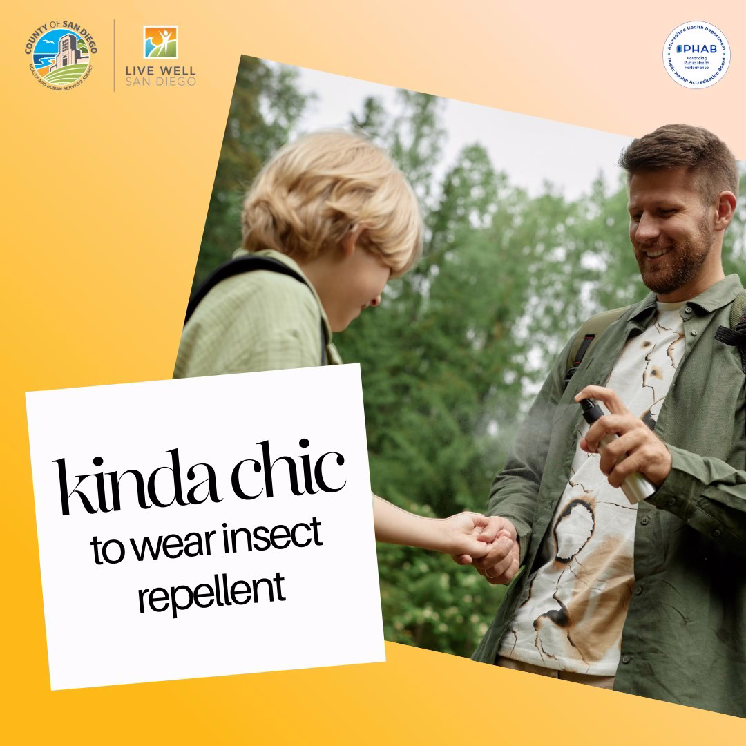 A dad spraying his son with insect repellent with text: kinda chic to wear insect repellent. 