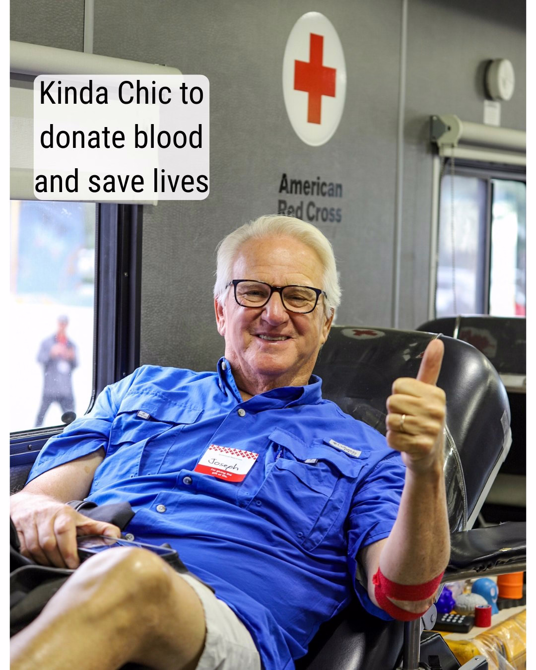A person seated in a blood donation chair giving a thumbs up, wearing casual attire. The background shows the American Red Cross logo. Text on the image reads, "Kinda Chic to donate blood and save lives."