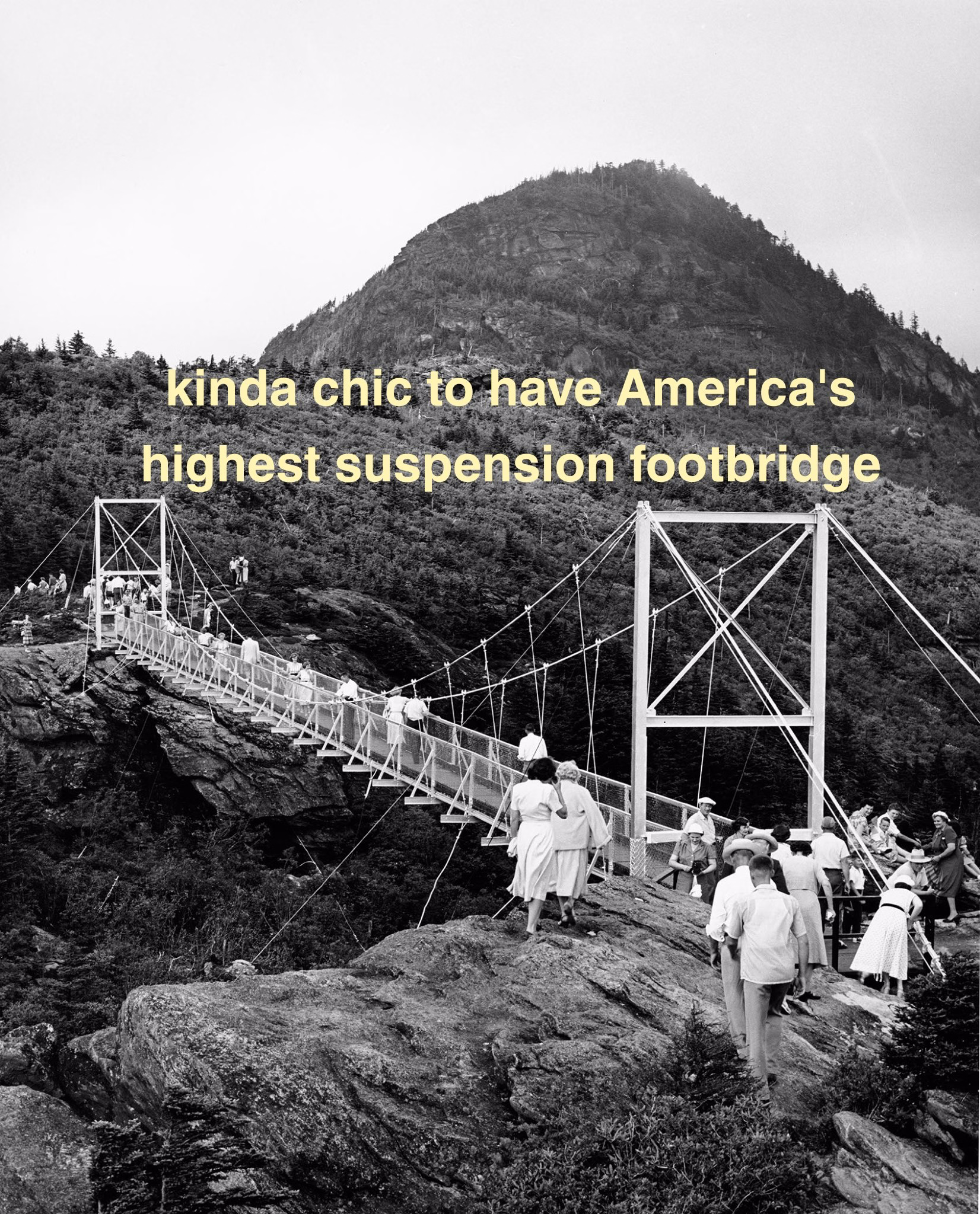 A group of visitors are walking on a historic suspension footbridge at Grandfather Mountain. The bridge spans between rocky cliffs with a mountain peak in the background. The image has a vintage feel, and there's text about the bridge being America's highest suspension footbridge.