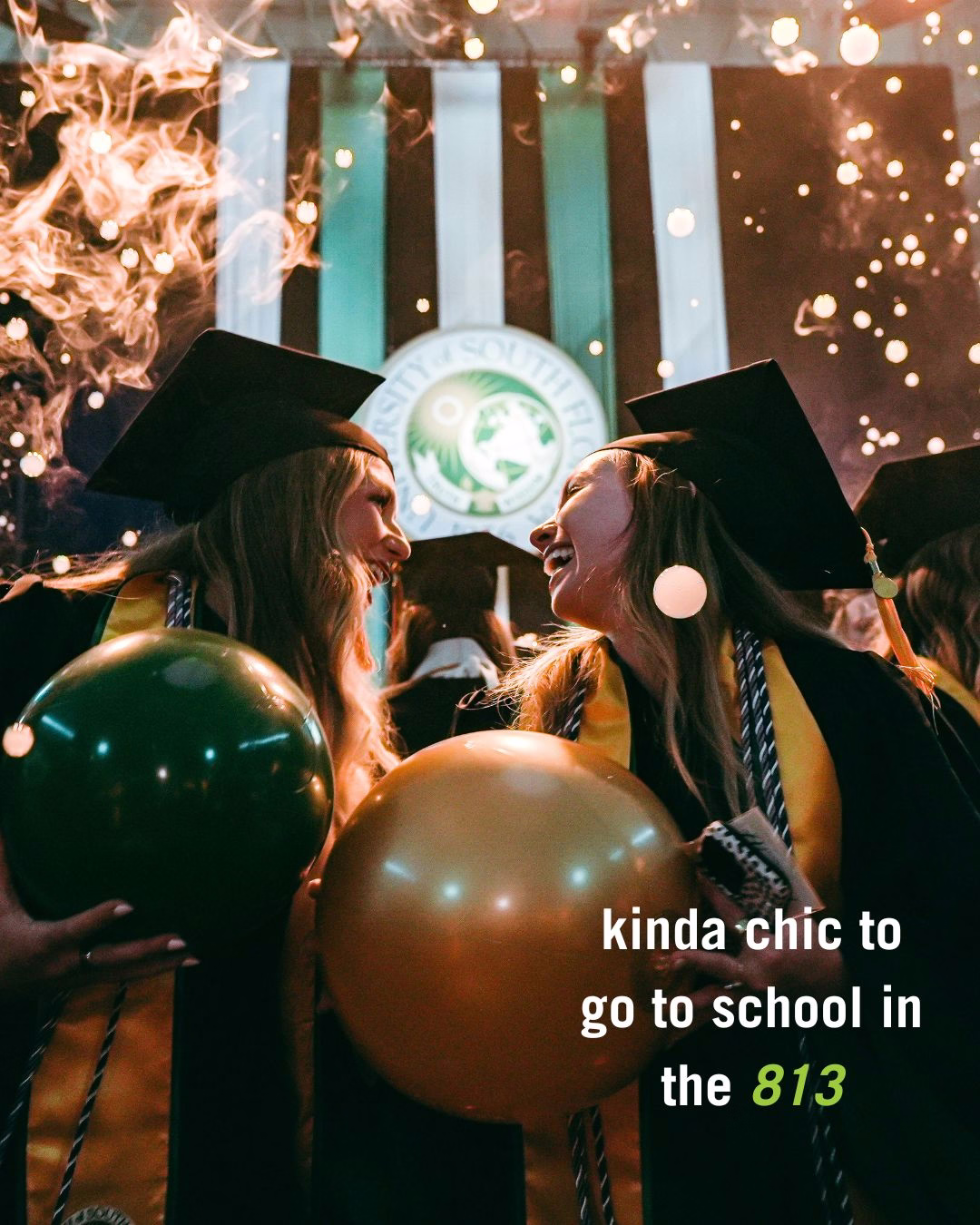 Graduates in caps and gowns celebrate at a University of South Florida commencement ceremony. They are holding large beach balls, and bubbles fill the air. Text on the image reads: "kinda chic to go to school in the 813."