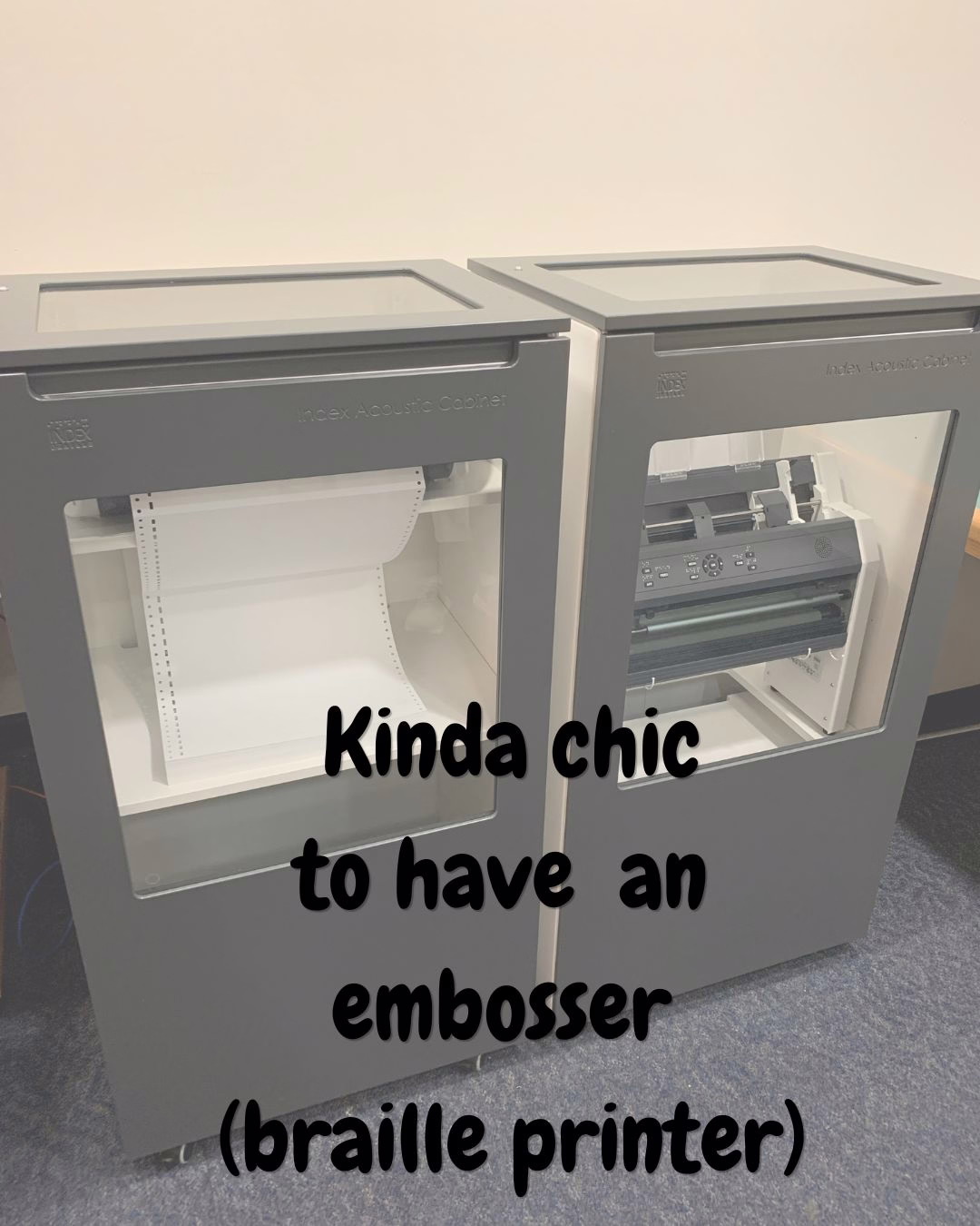 a large square piece of equipment along a beige wall. the equipment is in two columns, with a window showing a roll of paper and the second window showing tech that looks like a printer. Black chewy font text overlaid reads "kinda chic to have an embosser (braille printer)."